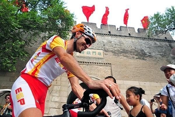 Samuel Sanchez, of Spain's cycling team, smiles at the locals