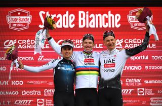 SIENA ITALY MARCH 08 LR Tom Pidcock of The United Kingdom and Q365 Pro Cycling Team on second place race winner Tadej Pogacar of Slovenia and UAE Team EmiratesXRG and Tim Wellens of Belgium and UAE Team EmiratesXRG on third place pose on the podium ceremony after the 19th Strade Bianche 2025 Mens Elite a 213km one day race from Siena to Siena 320m UCIWT on March 08 2025 in Siena Italy Photo by Tim de WaeleGetty Images