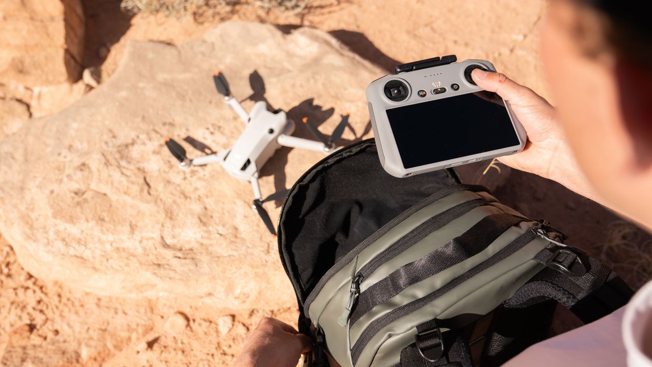The Wandrd Stratus camera backpack with a drone and the top zip open