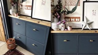 dark blue cabinet with rustic wood top and styled with various ornaments