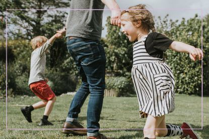 Adult running and laughing with kids