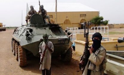 Fighters from the Al Qaeda-linked Islamist group MUJWA, are traveling with a convoy in northern Mali, on Aug. 7, 2012.