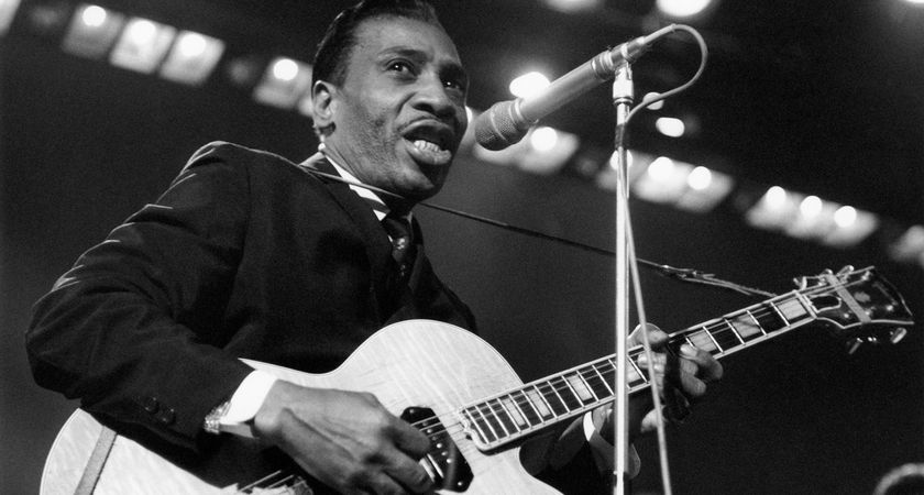 A black-and-white action shot of electric blues pioneer T-Bone Walker performing in the '60s.