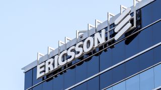 A close up photo of an Ericsson sign and its company logo on the side of a building