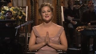 Drew Barrymore with his hands together at her chest on SNL