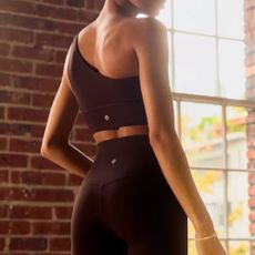 Woman with her back to the camera wearing Lululemon leggings and sports bra