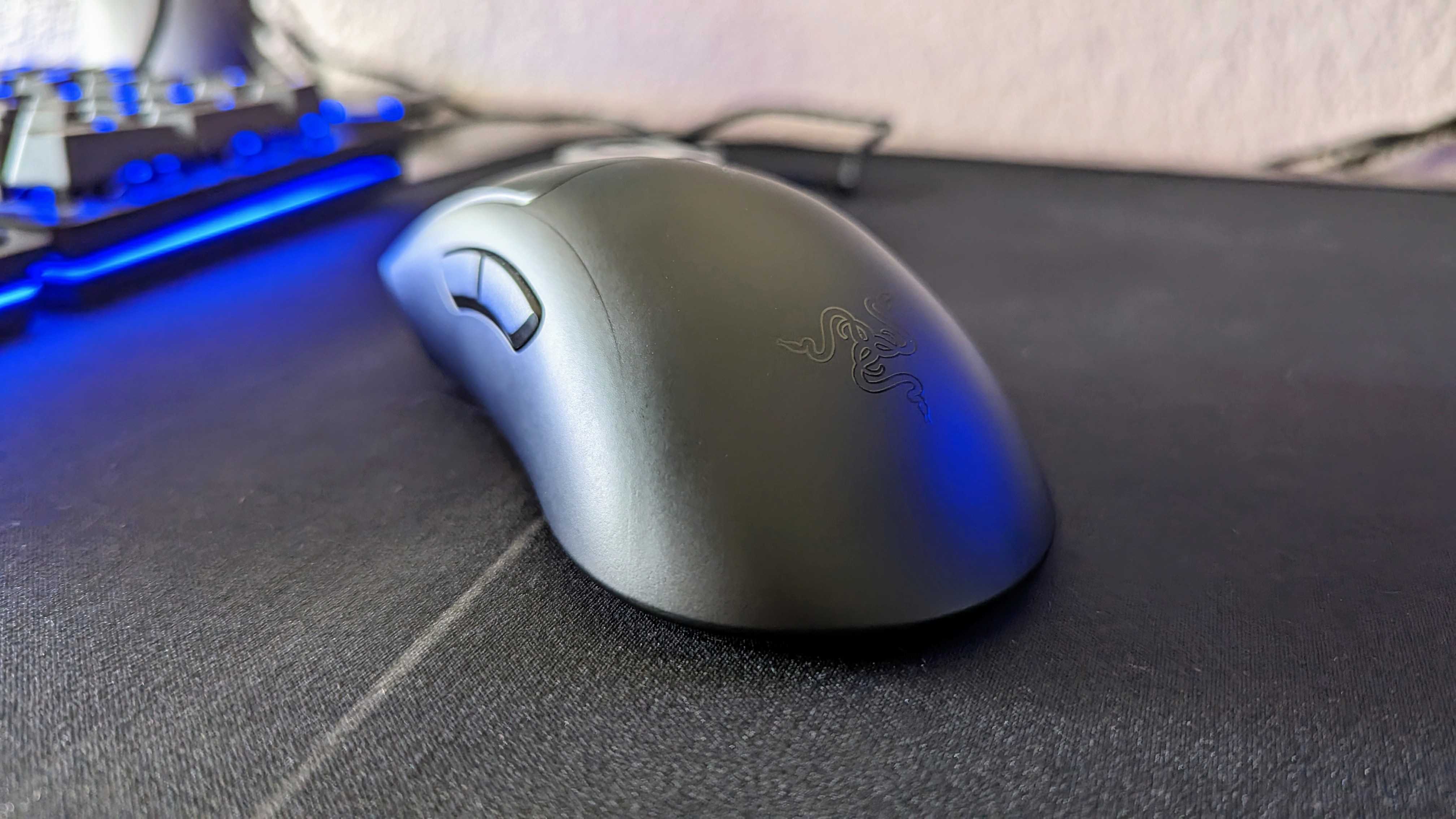 The Razer DeathAdder V3 on a mousepad, seen from the rear.