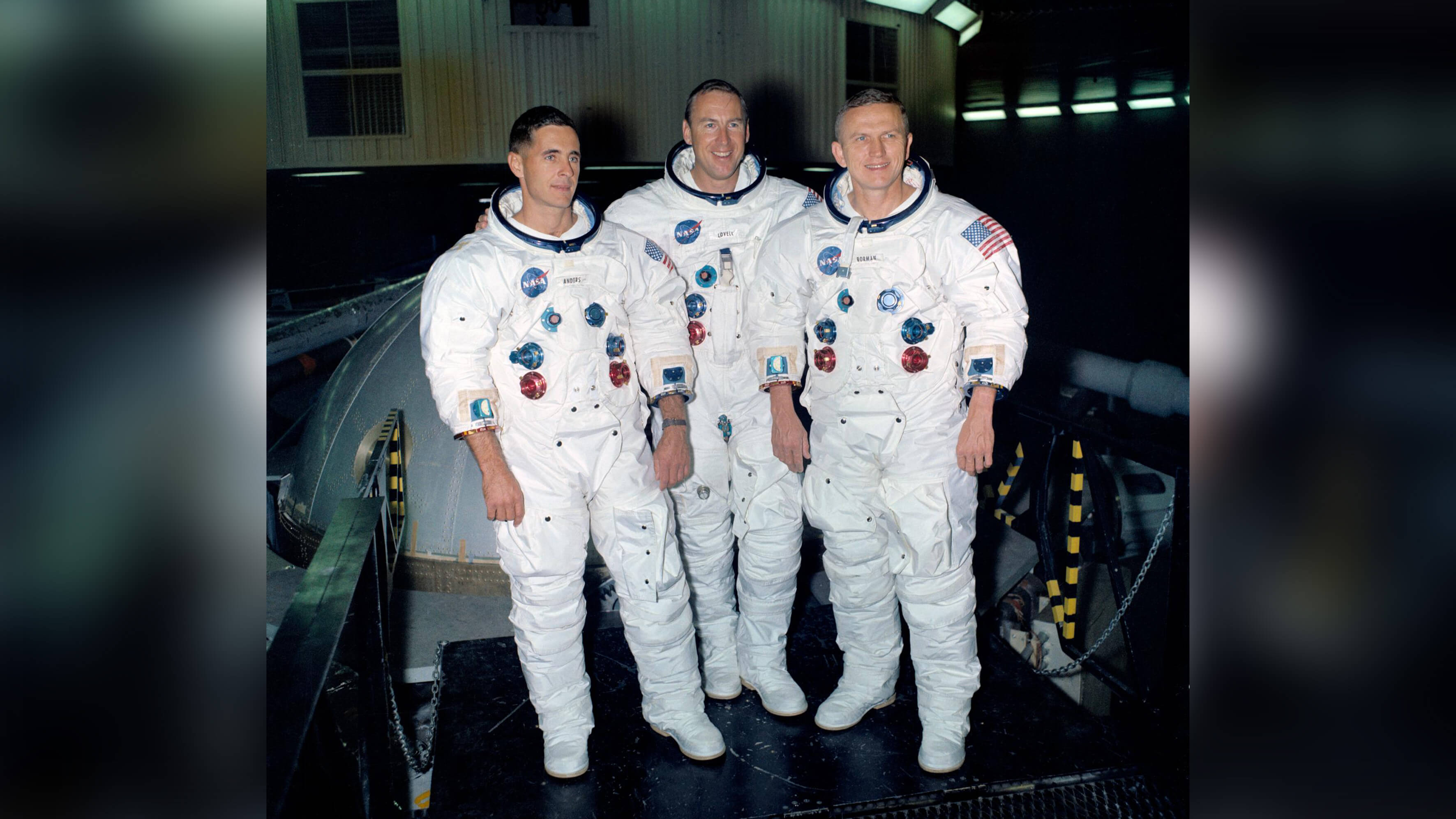 Apollo 8 crew in space suits but without helmets.