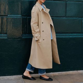 Cropped image of woman wearing trench coat