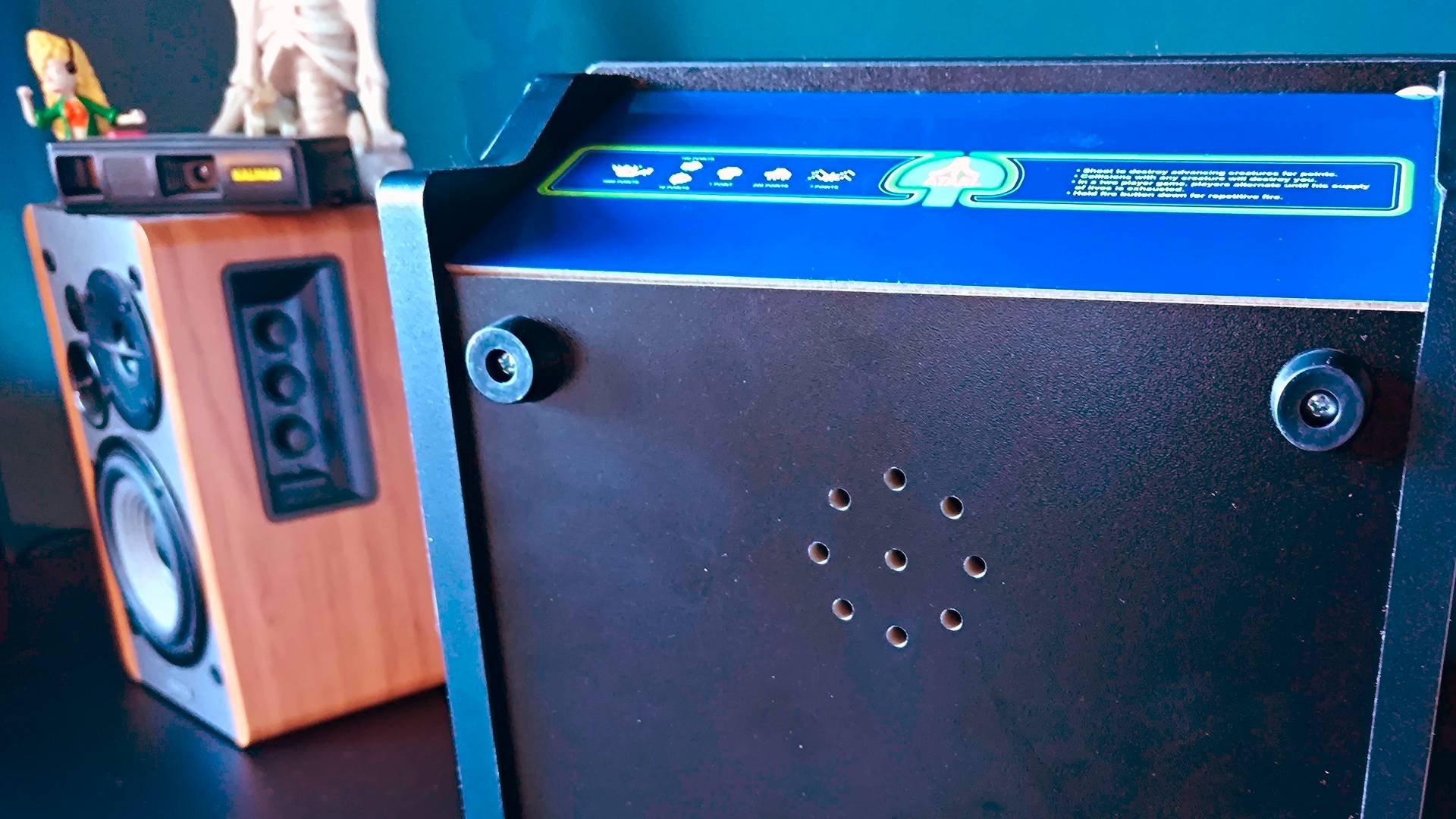 Bottom of Arcade Classics cabinet with speaker holes in view.