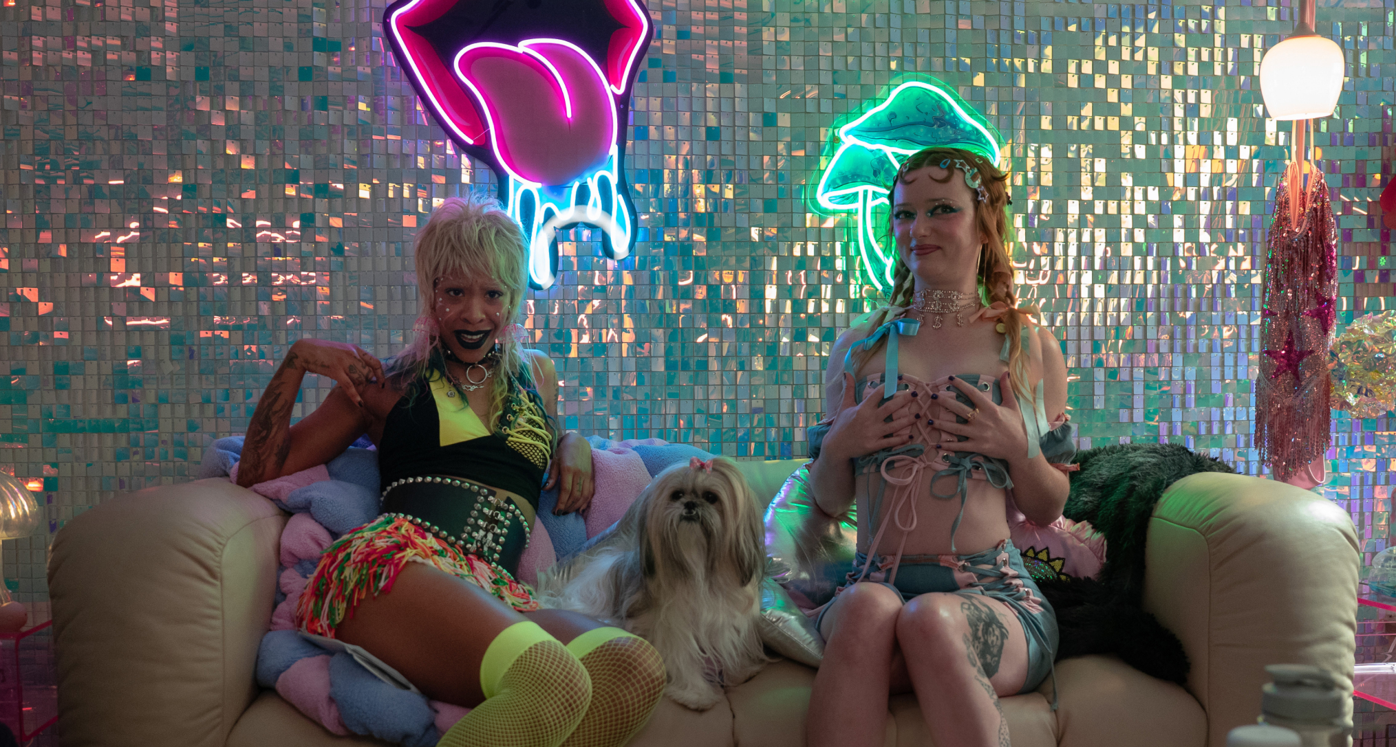 rico nasty as kc and lindsey normington as rose sitting on a leather couch with a dog while making onlyfans content in margo's got money troubles