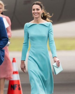 Kate Middleton wearing a blue long sleeved dress