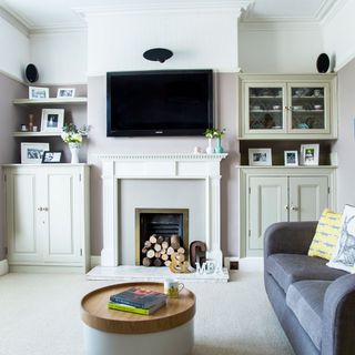 living room with white wall and flooring and sofa set with round teapoy