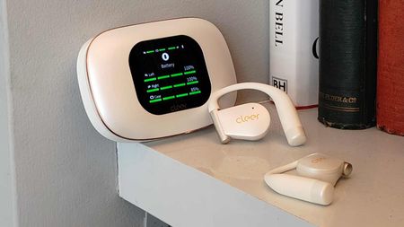 The Cleer Arc 5 buds in a shelf, next to the case.
