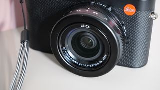 The Leica D-Lux 8 on a grey and pink background