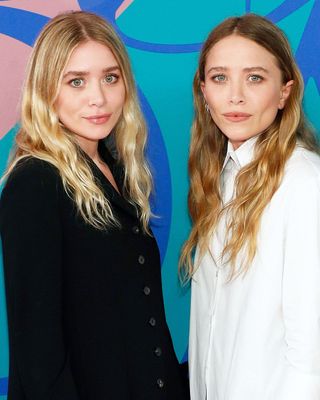 The Olsen twins with long wavy hair.