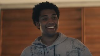 Chance Perdomo's Andre wearing a hoodie and smiling in Gen V