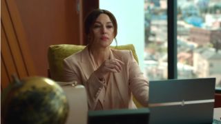 Monica Bellucci sits with authority in front of a laptop on her desk in Memory,