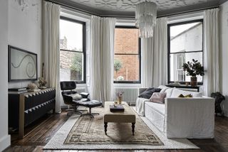 living room with white sofa and large area rug