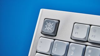 The NuPhy Nos75 mechanical keyboard on a stone surface with a blue background