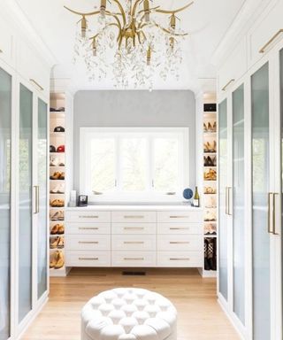 luxury white walk-in wardrobe with chandelier