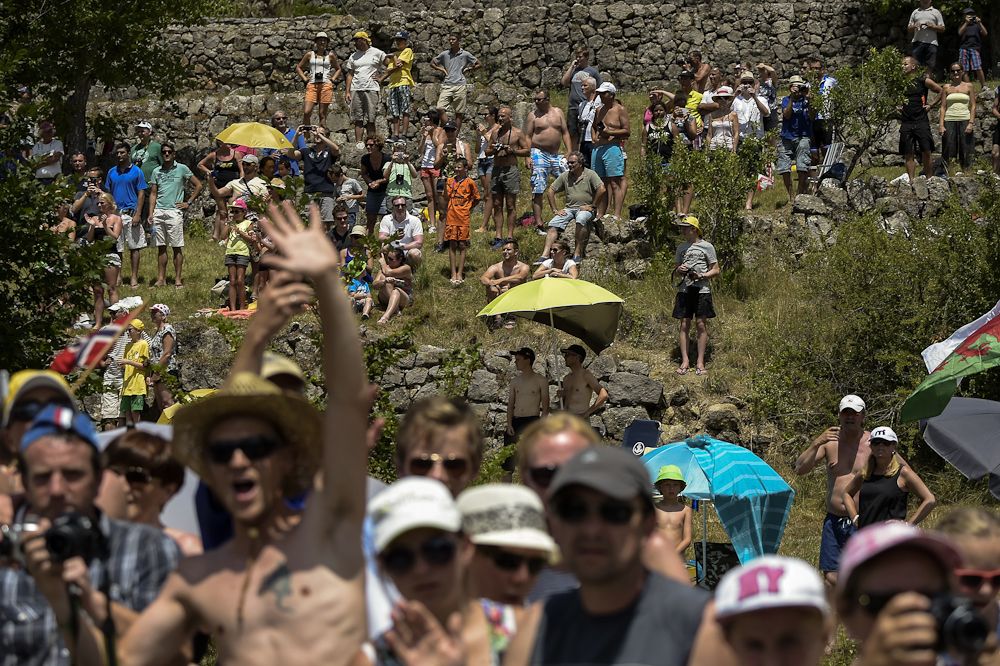 Spectators wait for the riders to arrive during stage 17.