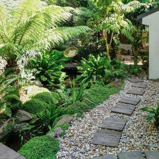 wild garden with stepping stones on right, yellow chair in background