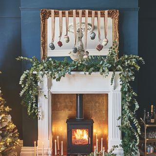 Christmas Garland on mantlepiece with hanging baubles from mirror