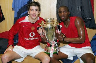 Gerard Pique and Floribert Ngalula of Manchester United celebrate with the league trophy in the dressing room after the Barclays Premier Reserve League match between Manchester United Reserves and Manchester City Reserves at Old Trafford on April 28 2005 in Manchester, England.