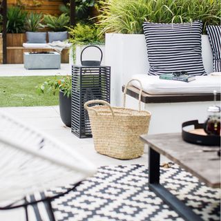 outdoor patio area with seating and black and white rug