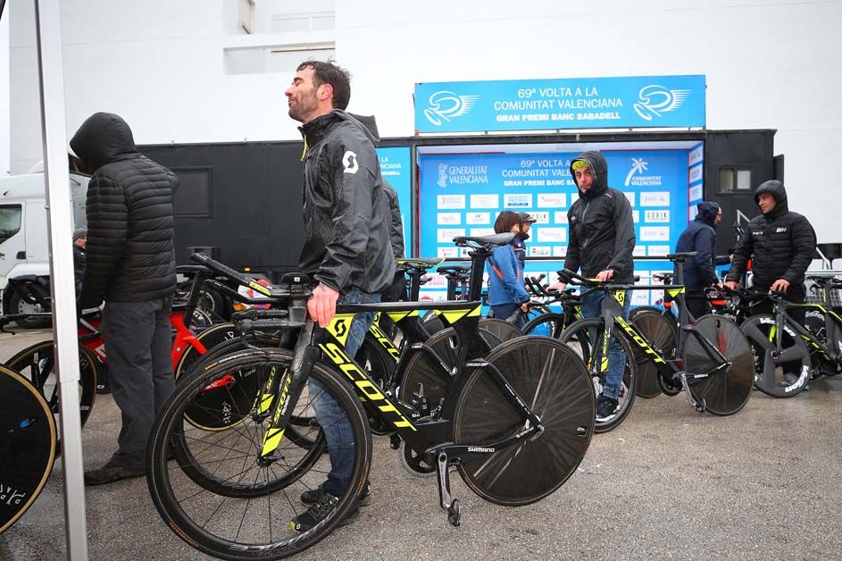 Mechanics wait to get the bikes weighed