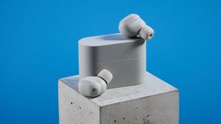 Sony WF-1000XM6 earbuds photographed in front of a blue background