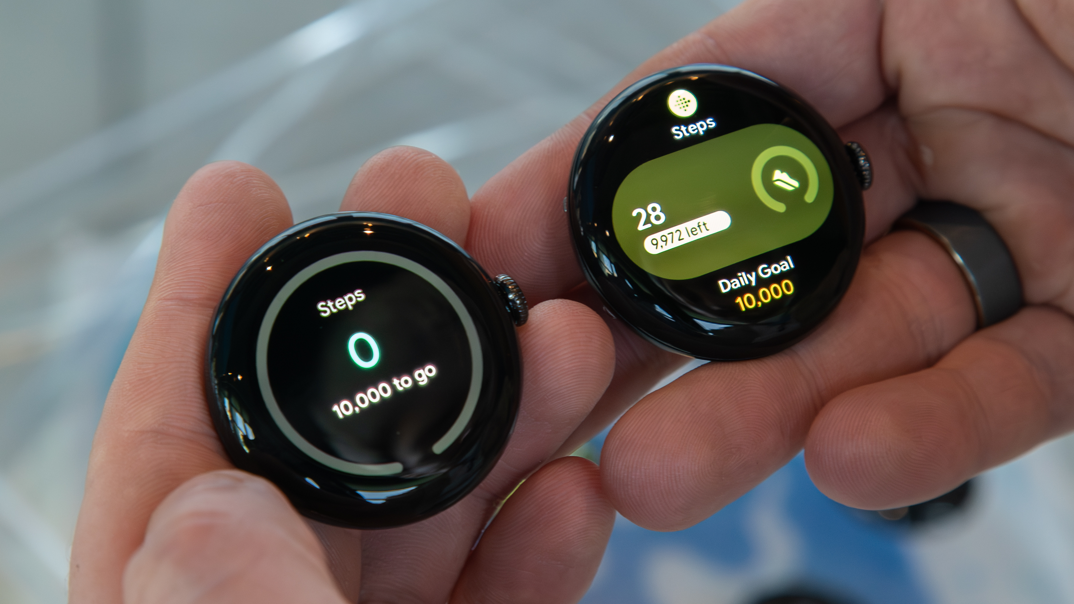 Pixel Watch 4 (right) next to the original Pixel Watch (left) showing Fitbit steps tile