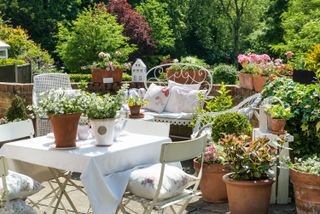 patio gardening ideas: potted plants around patio seating