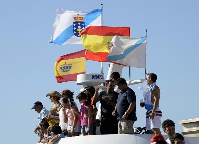 Fans watch from the top of a boat