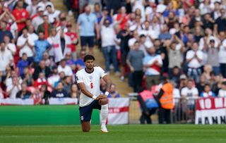 England’s Tyrone Mings takes the knee