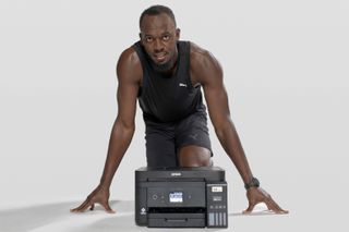 Usain Bolt posing behind an Epson printer