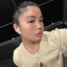 Allison Ho taking an elevator selfie with glowing skin