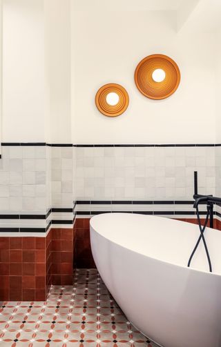 A bathroom with mixed pattern tiles