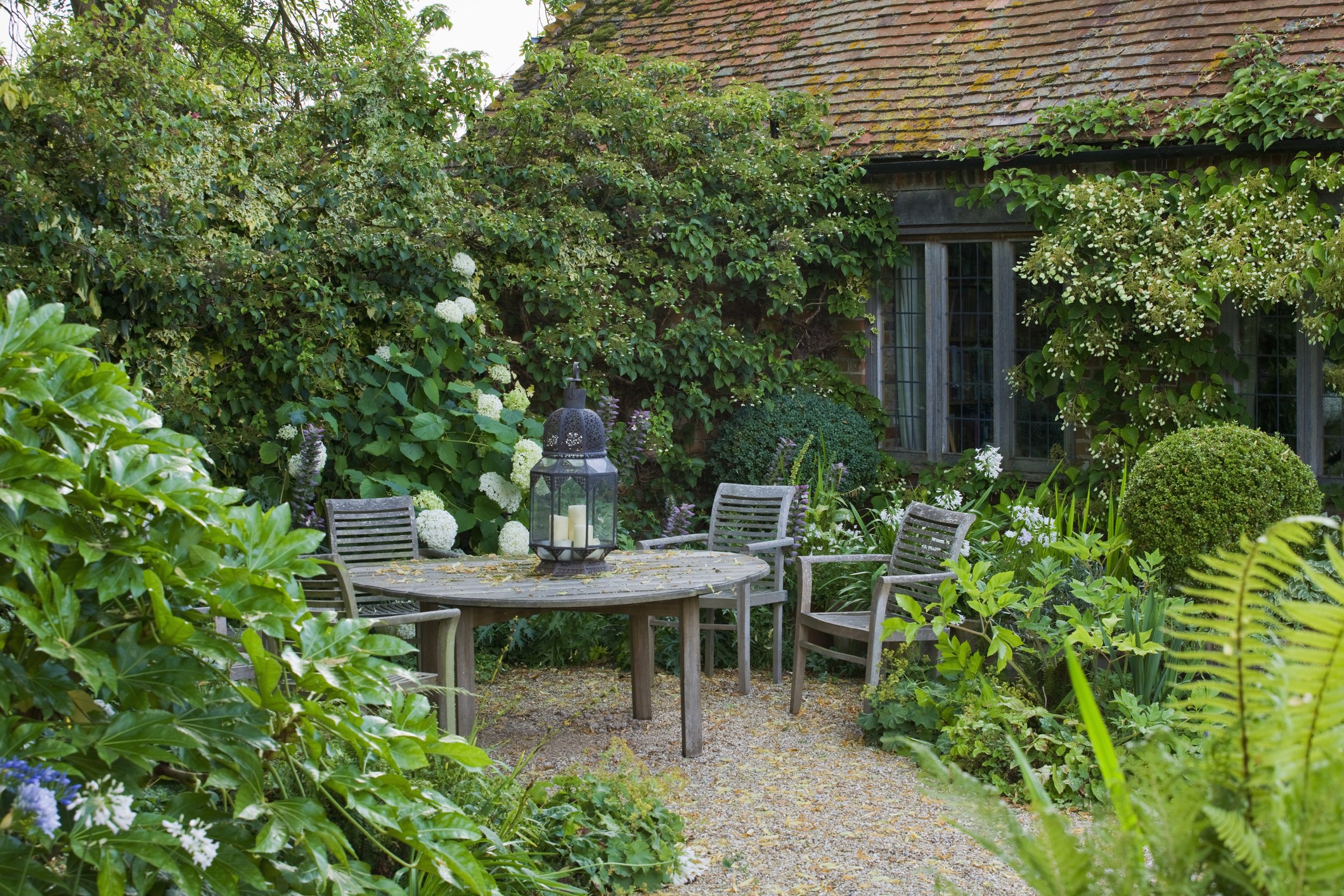 a cottage garden with a dining table