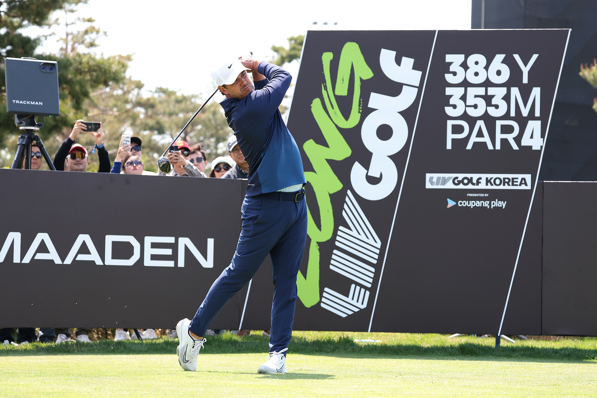 Brooks Koepka hitting a tee shot with driver at a LIV Golf event