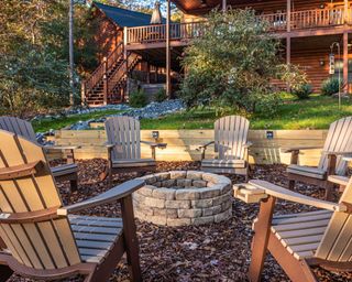 stone brick fire pit surrounded by chairs