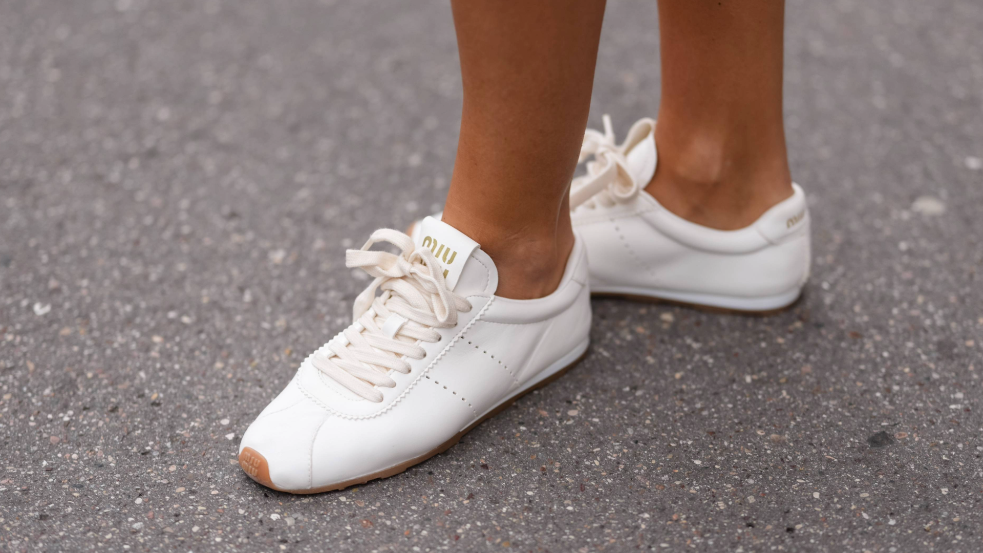 woman wearing white sneakers