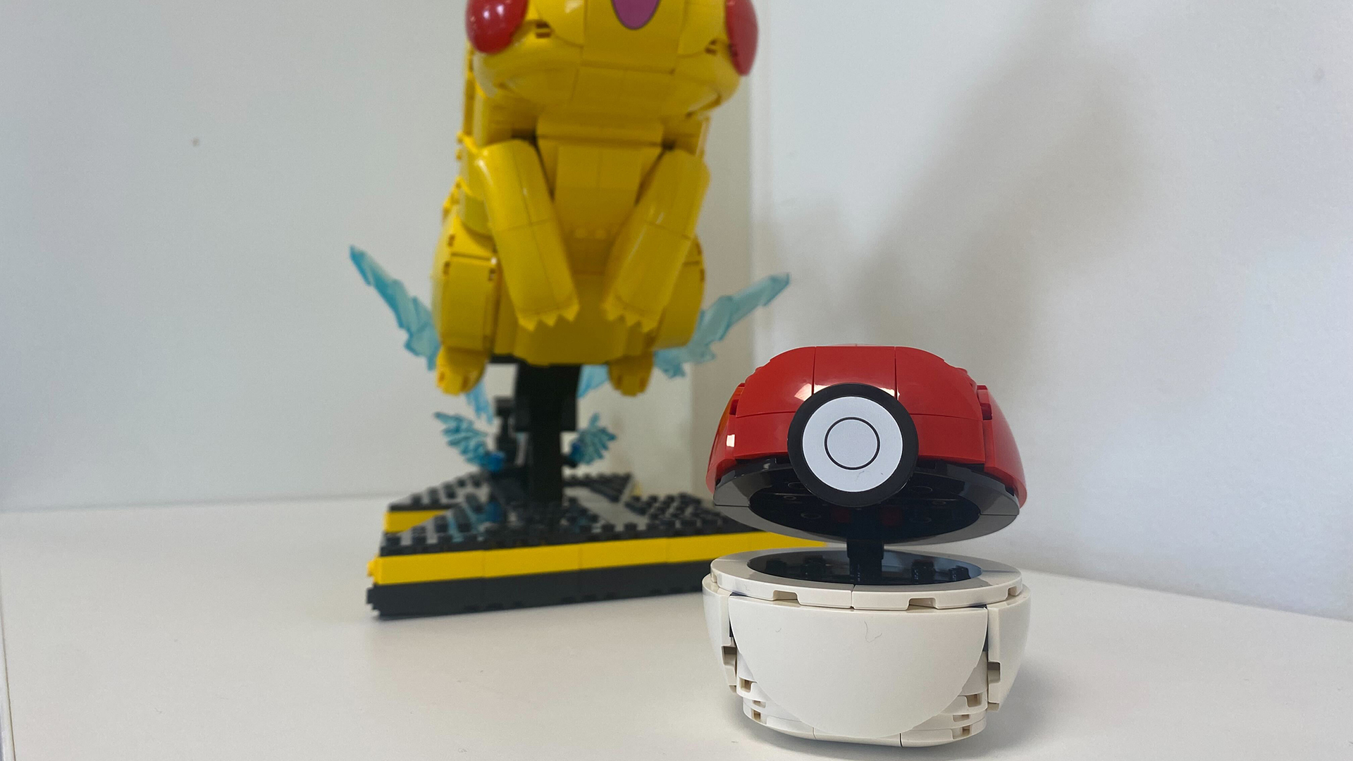 Lego Pikachu and Poke Ball set against a white background