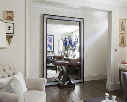 A living room mirror idea with an oversized mirror leant against the wall
