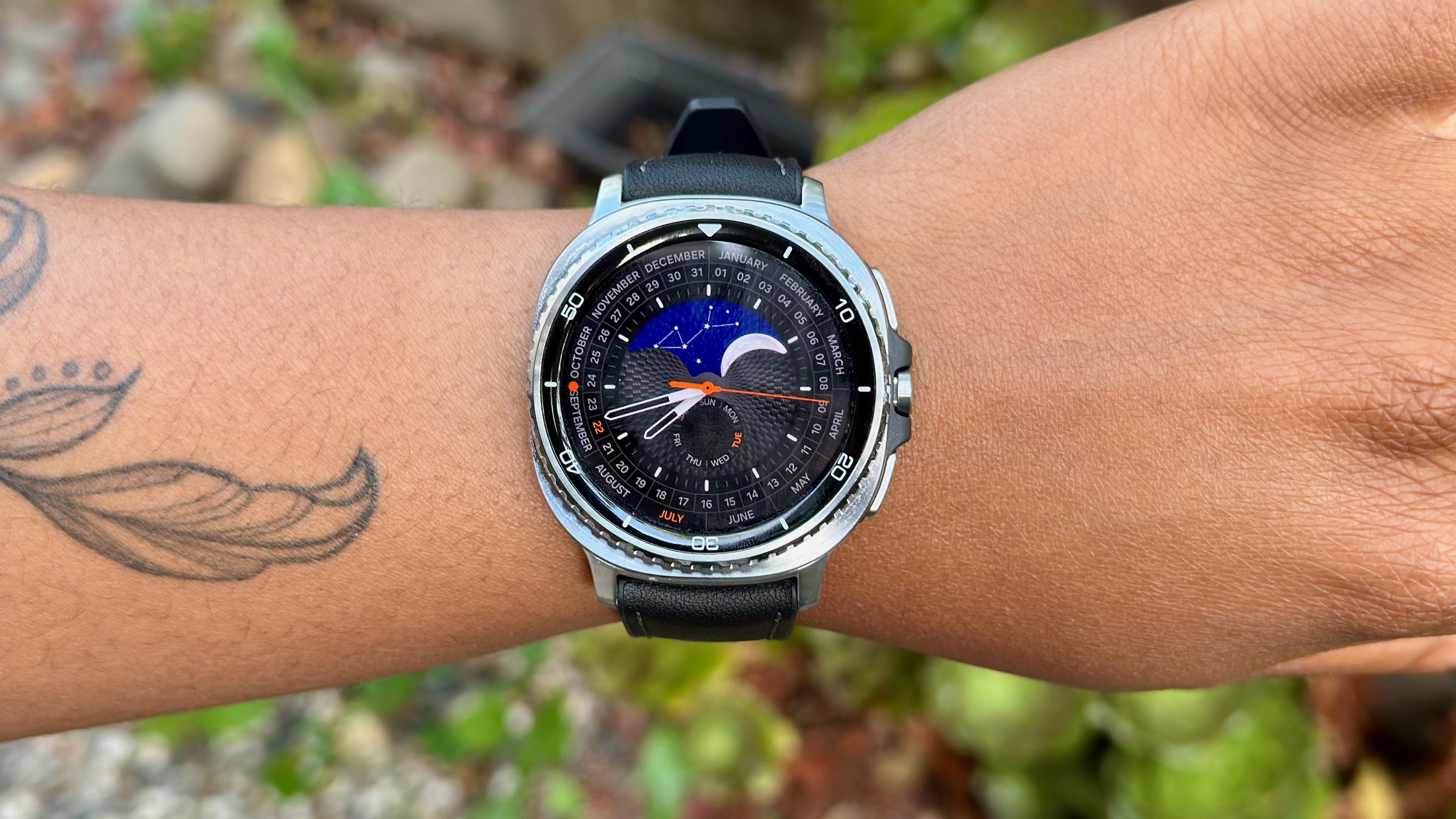 A close-up of the Samsung Galaxy Watch 8 Classic on a woman&#039;s wrist showing the Heritage Classic watch face.