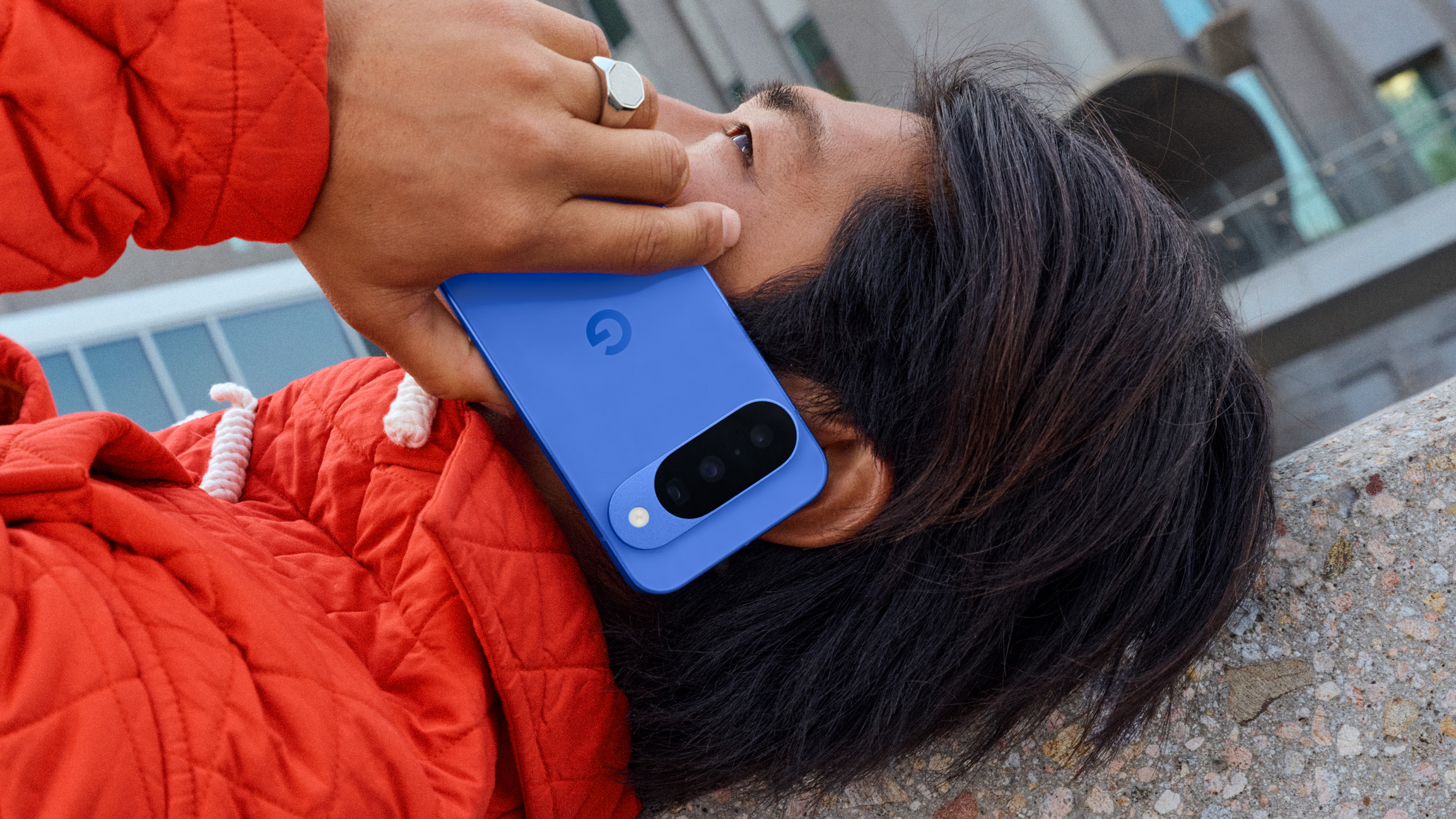 Google Pixel 10 held to user's head while laying down