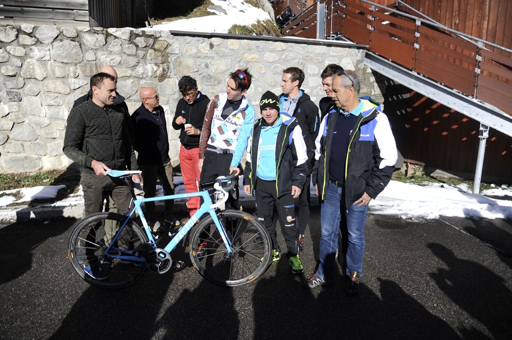 Riders and staff inspect their new bike