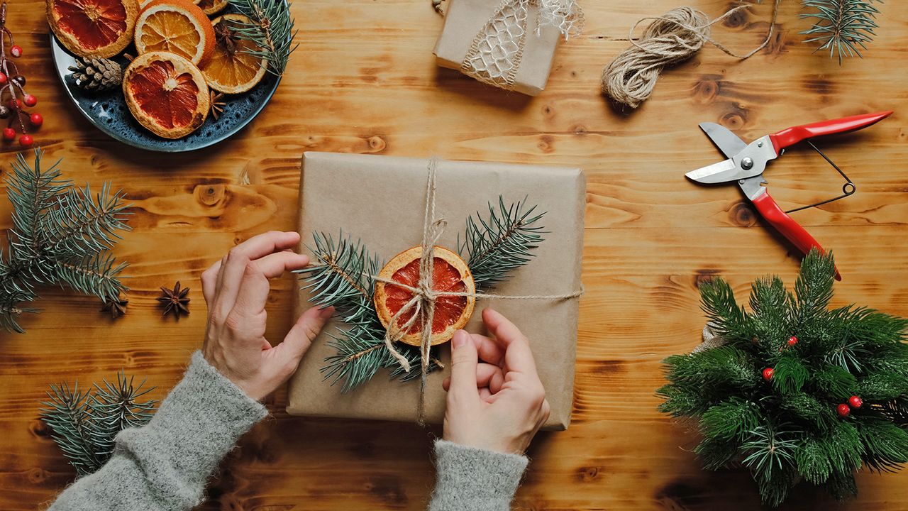 Wrapping festive gifts with sustainable paper and natural foliage