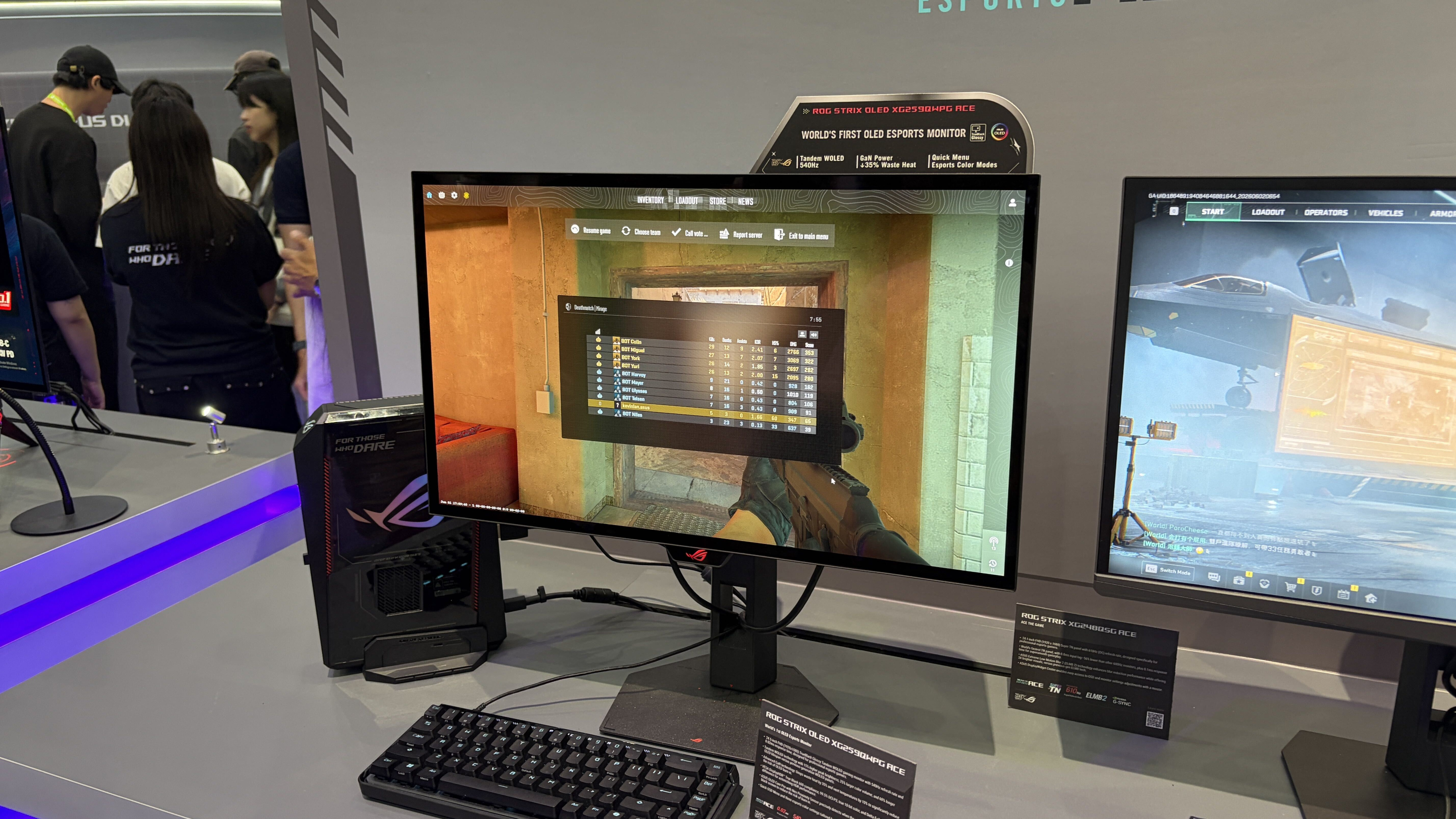 ASUS gaming setup featuring a monitor displaying a first-person shooter game with a visible ROG console.